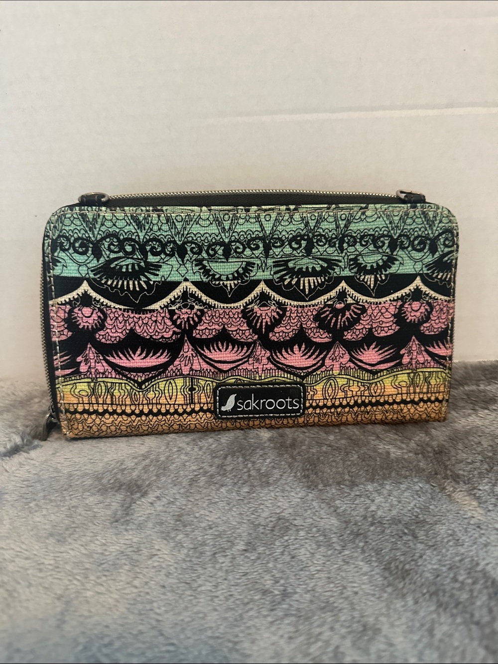 Sakroots Women's Smartphone Wallet stains from use, as shown in pictures